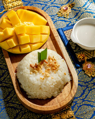 Golden mango glistens beside fragrant sticky rice, evoking Songkran feasts and exotic Thai culinary...