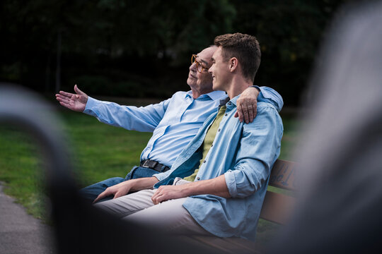 Family members enjoying conversation on park bench outdoors