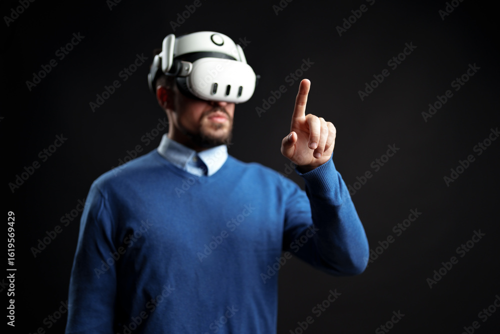 Poster user engages with virtual reality headset while pointing in an immersive digital environment