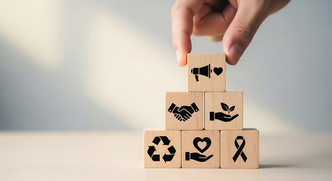 Hand arranging wooden blocks symbolizing core values and community outreach
