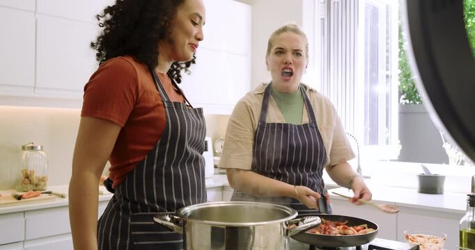Diverse female friends under ring light stirring pot scooping peppers, flipping mix and seasoning
