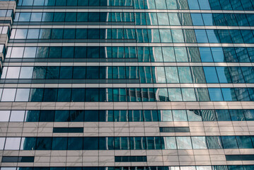 walls and empty windows of a modern building on a big city street without people