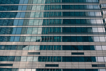 walls and empty windows of a modern building on a big city street without people
