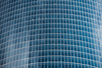 walls and empty windows of a modern building on a big city street without people