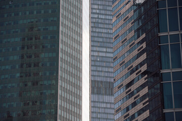 walls and empty windows of a modern building on a big city street without people
