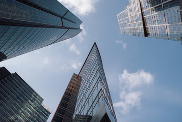 bottom view of the tall skyscrapers of the business district of a modern city