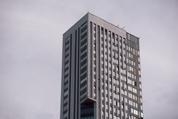 Fototapeta premium empty glass windows of a modern building with a reflection of the sky in the glass