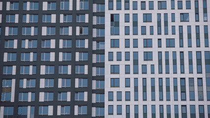 Fototapeta premium empty glass windows of a modern building with a reflection of the sky in the glass