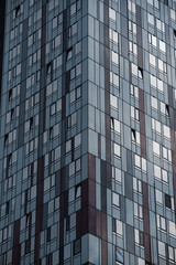 Fototapeta premium empty glass windows of a modern building with a reflection of the sky in the glass