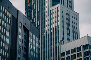 Fototapeta premium empty glass windows of a modern building with a reflection of the sky in the glass