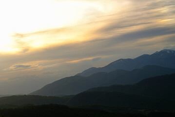 Rolling hills and sunset sky over serene mountain nature landscape. Armenia