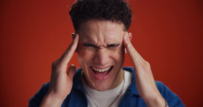 Man, headache and pain with vertigo in studio for intense strain on a red background. Male person, migraine or model with temple tension, cluster or nausea for chronic illness, stress or pressure