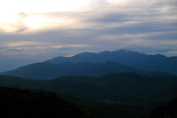 Rolling hills and cold evening sky over serene mountain nature landscape