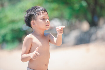 Young Boy Pointing on Beach