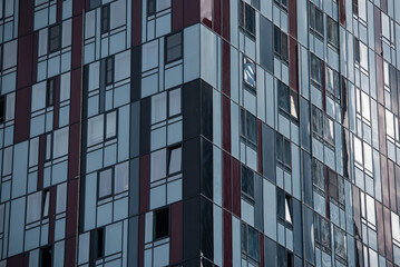 empty glass windows of a modern building with a reflection of the sky in the glass