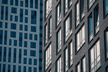 Fototapeta premium empty glass windows of a modern building with a reflection of the sky in the glass