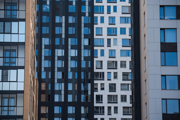 empty glass windows of a modern building with a reflection of the sky in the glass