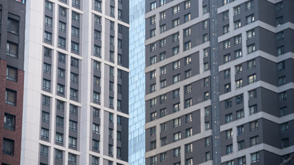 empty glass windows of a modern building with a reflection of the sky in the glass
