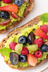 Avocado toast with strawberry, blueberry, raspberry and grape. Healthy eating