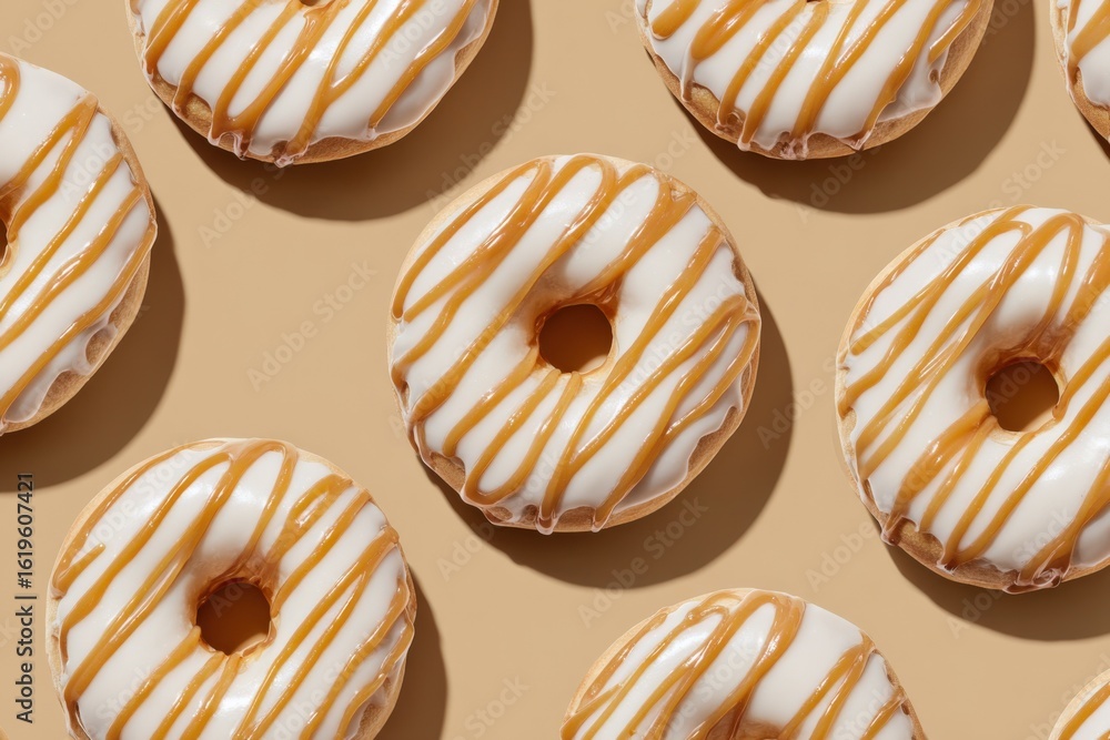 Poster assorted glazed donuts with white icing and caramel drizzle arranged on beige background for baking 
