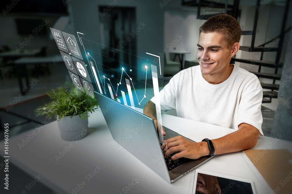 Poster young man analyzing data on a laptop with digital graphs in a modern workspace during daytime