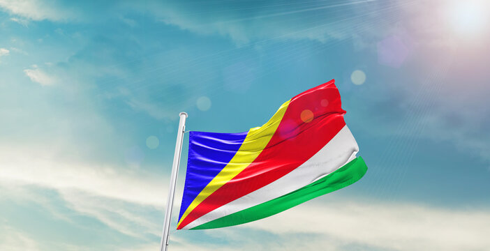 Seychelles national flag waving with beautiful sky.