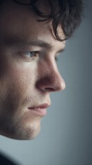 Fototapeta premium Pensive young Caucasian man gazes pensively, evoking introspective moments akin to the meditative reverie of Solstice reflections