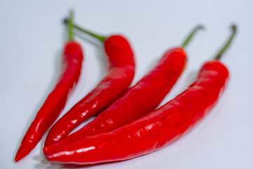 Close-up of fresh chili peppers on a plain white background, ideal for recipe websites, kitchen...
