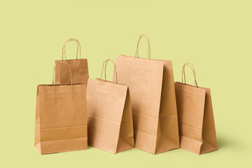 Many paper shopping bags on green background