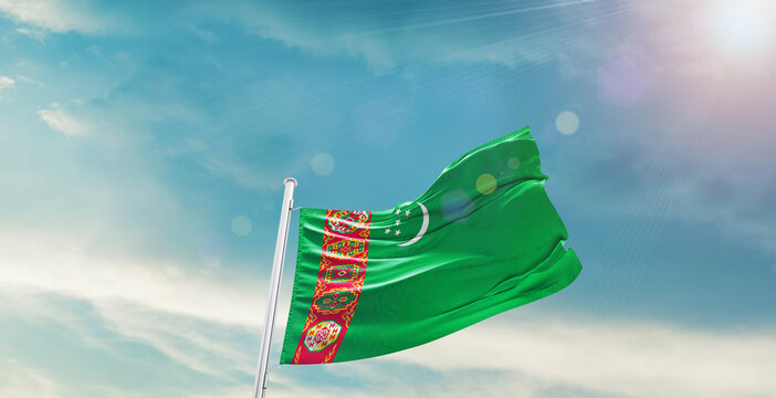 Turkmenistan national flag waving with beautiful sky. - Powered by Adobe
