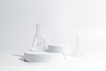 science with transparent glass erlenmeyer flask and funnel and beaker filled with colorless liquid water on a white cylinder base stand on desktop tabletop display with a simple clean background