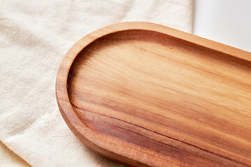wooden tray oval base and stand with wood texture on white canvas cloth on desktop tabletop background