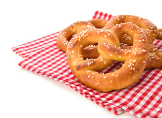 Tasty salted pretzels on white background