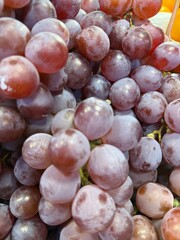 Fresh red globe grapes cluster shows juicy texture and subtle colors in close up