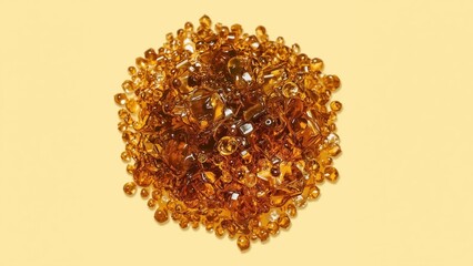 Shilajit honey. Amber beads close-up on yellow background, natural gem