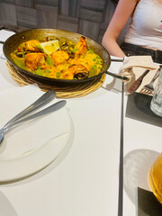 Traditional Spanish paella cooked in a large pan, served fresh in Barcelona