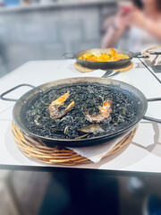 Traditional Spanish paella cooked in a large pan, served fresh in Barcelona