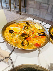 Traditional Spanish paella cooked in a large pan, served fresh in Barcelona