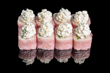 Elegant pink sushi rolls topped with decorative cream cheese swirls, beautifully arranged on a...