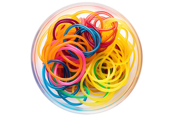 Vibrant colorful rubber bands tangle in a clear bowl, creating a playful and energetic abstract composition.