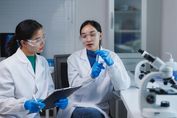 Scientists working with test tubes in laboratory researching new medicine
