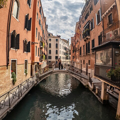  Girl posing on a bridge in Venice over a canal