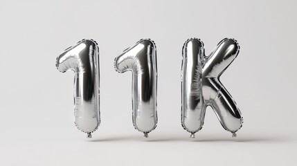 Silver 11k foil balloons on light gray background celebrating milestone achievement