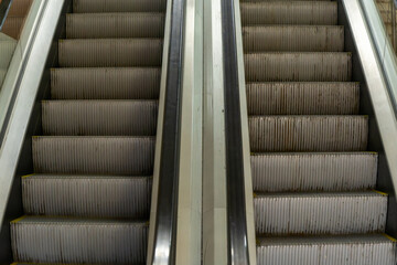 Symmetrical Escalator Steps Ascending Towards Progress And Success. Urban Escalator In Motion Capturing The Essence Of Modern Transportation. Concept image.