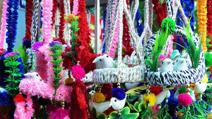 Fototapeta premium Decorative items made with thread and plastic materials on display in a shop at Rameswaram, Tamil Nadu, India
