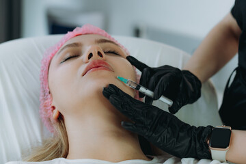young woman getting an injection procedure in aesthetic clinic. Beauty treatment
