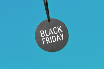 Black friday word on sale tag on blue background