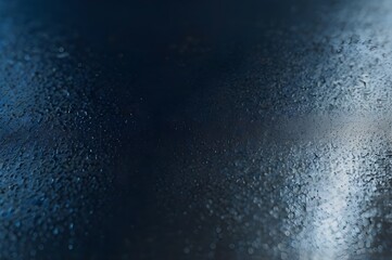 A close-up view of water droplets and condensation on a glass surface, illuminated by soft natural light. The image creates a moody and atmospheric background, perfect for use in weather, nature.
