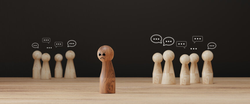 Sad wooden figure excluded from group. Concept of bullying, discrimination, isolation, loneliness, and mental health in society, workplace or school.