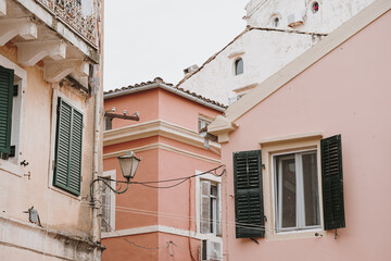 Naklejka premium Elegant Windows with Shutters Framed by a Pink Wall